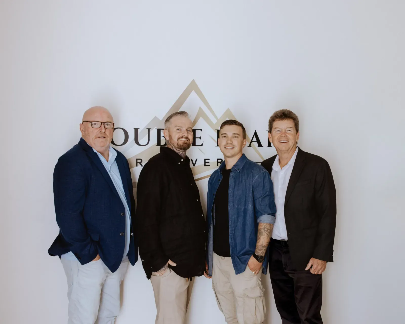 Double Peak Recovery leadership standing beneath the facility sign